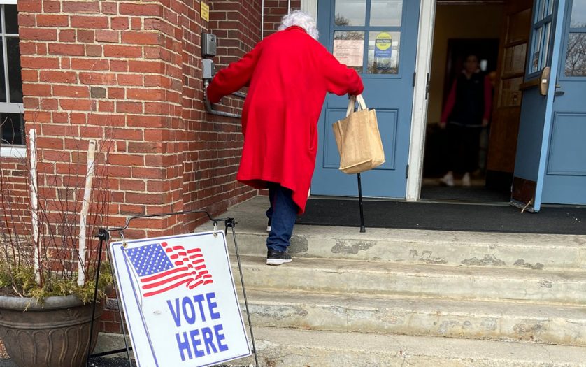 Old Woman Voter Entering Voting Polling Place for USA Government Election