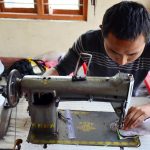 Man sew cotton by Sewing machine