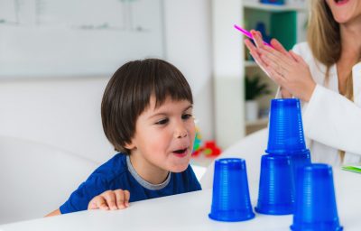 toddler doing tests with plastic cups