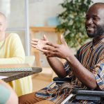 Disabled businessman talking at meeting