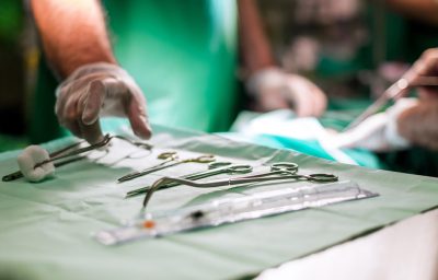 Doctor taking surgery tools during surgery
