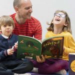 person with two kids smiling