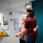 woman with intellectual dancing with caregiver at home