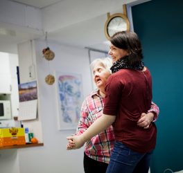 woman with intellectual dancing with caregiver at home