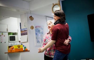 woman with intellectual dancing with caregiver at home