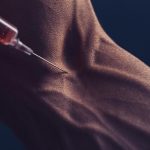 muscular man with syringe