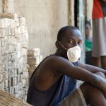 A young man wears a mask in Gonaives, Haiti.