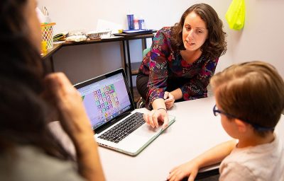 Teachers working with student