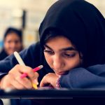 student taking notes in the classroom