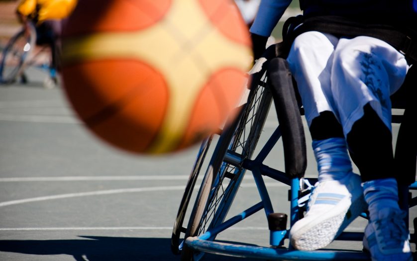 basketball player in the wheelchair, motion blur on ball
