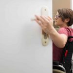 disabled woman at the open door with space