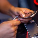 A man is repairing a mobile phone