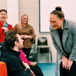 Carmel Sepuloni speaking with a person with disability