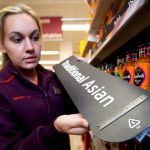 Lady at Sainsbury's store showing Braille signage exemplar.