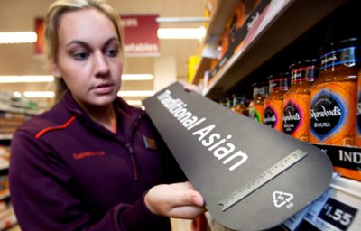 Lady at Sainsbury's store showing Braille signage exemplar.