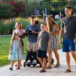 Boy using standing wheelchair with his family outdoor