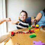 Mother and son playing together at a table