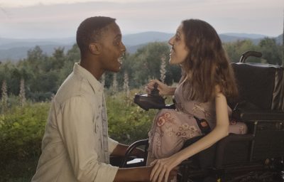 a woman in wheelchair with a man