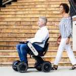 Man in Bird Electonic wheelchair with a woman