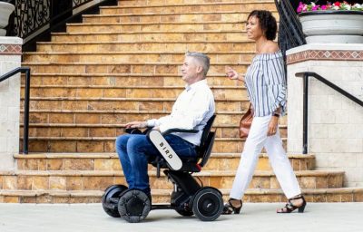 Man in Bird Electonic wheelchair with a woman