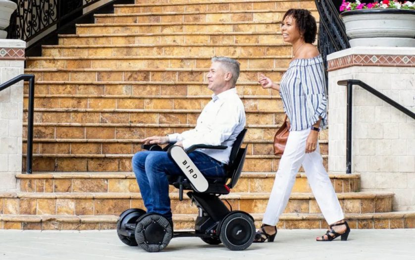 Man in Bird Electonic wheelchair with a woman