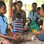 world vision staff talking with a person with disability