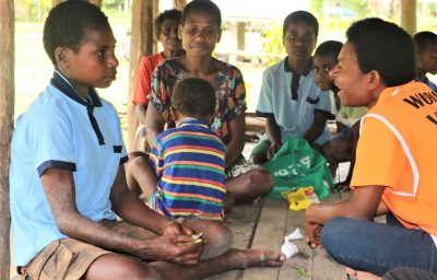 world vision staff talking with a person with disability