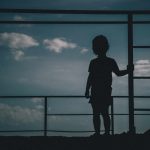 silhouette of kid looking sky