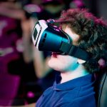 Side view of young using virtual reality goggles