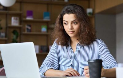 indian student using laptop watching online virtual training