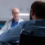 Close up of adult with disability having consultation with doctor