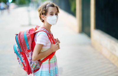 School girl with mask on