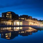 Scottish Parliament building is reflected in water