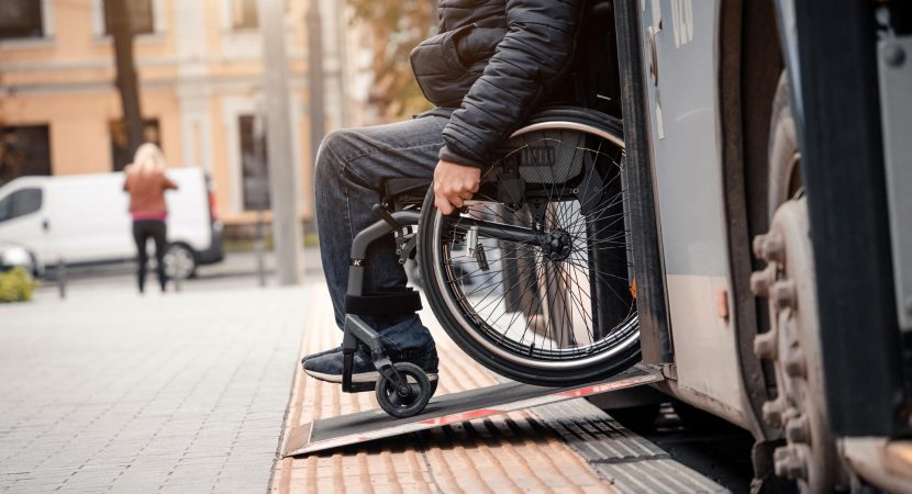 wheelchair user exits public transport with accessible ramp