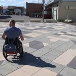 Rear view of a wheelchair user in the street