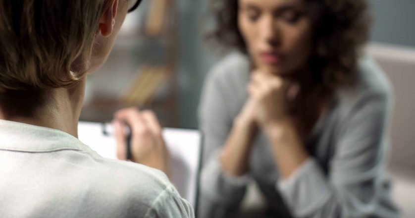 woman conversing with doctor