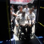 Wheelchair user boarding public transportation specifically designed in Solo , Central Java , Indonesia