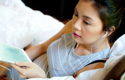 A woman is listening to podcast