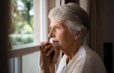 older woman standing near the window