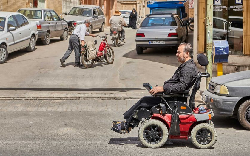 Man in electronic wheelchair in the street