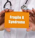 doctor holding Fragile X syndrome card