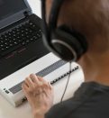 blind person hands using computer with braille display