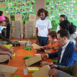Ambassador Jacobson, USAID Director Jones, and Ministry of Finance Director for Bilateral Cooperation Kokeb Misrak join the deaf, female workers of TEKI Paper Bags PLC in producing recycled paper bags by hand