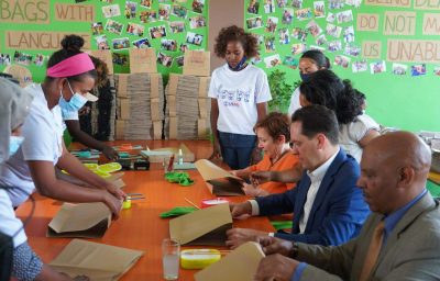 Ambassador Jacobson, USAID Director Jones, and Ministry of Finance Director for Bilateral Cooperation Kokeb Misrak join the deaf, female workers of TEKI Paper Bags PLC in producing recycled paper bags by hand