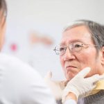 Female doctor check throat