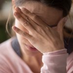 woman touching face having depression