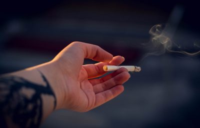 Close-Up Photography of a Person Holding Cigarette