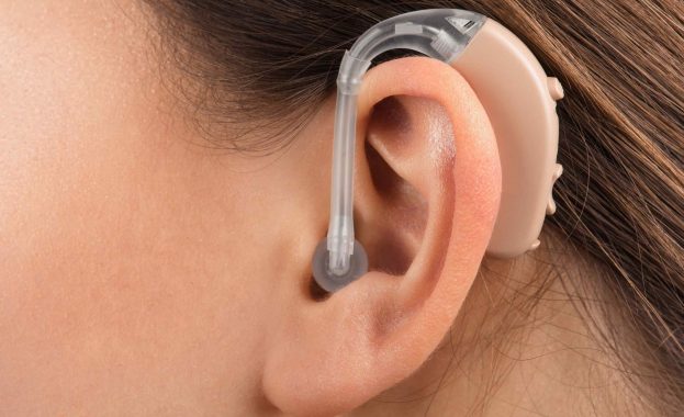 hearing aid in the ear of a woman