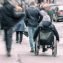 man in a wheelchair on a busy street