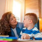 mother helping her son doing homework